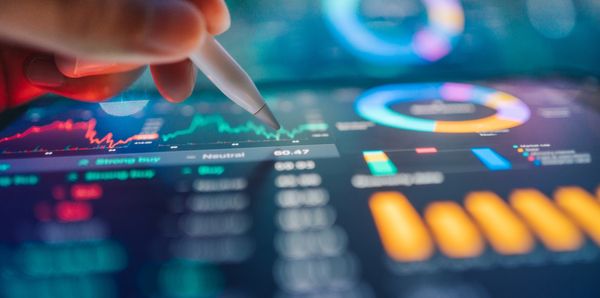 Analyzing financial data on a digital screen with a stylus pen.