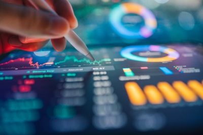 Person analyzing digital financial charts with a stylus.