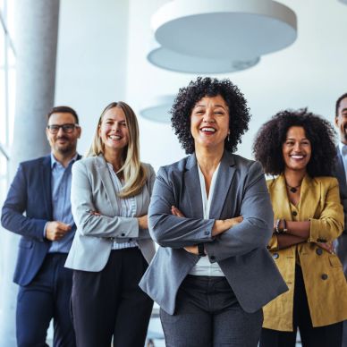 four people, 2 women and one man dressed as executives