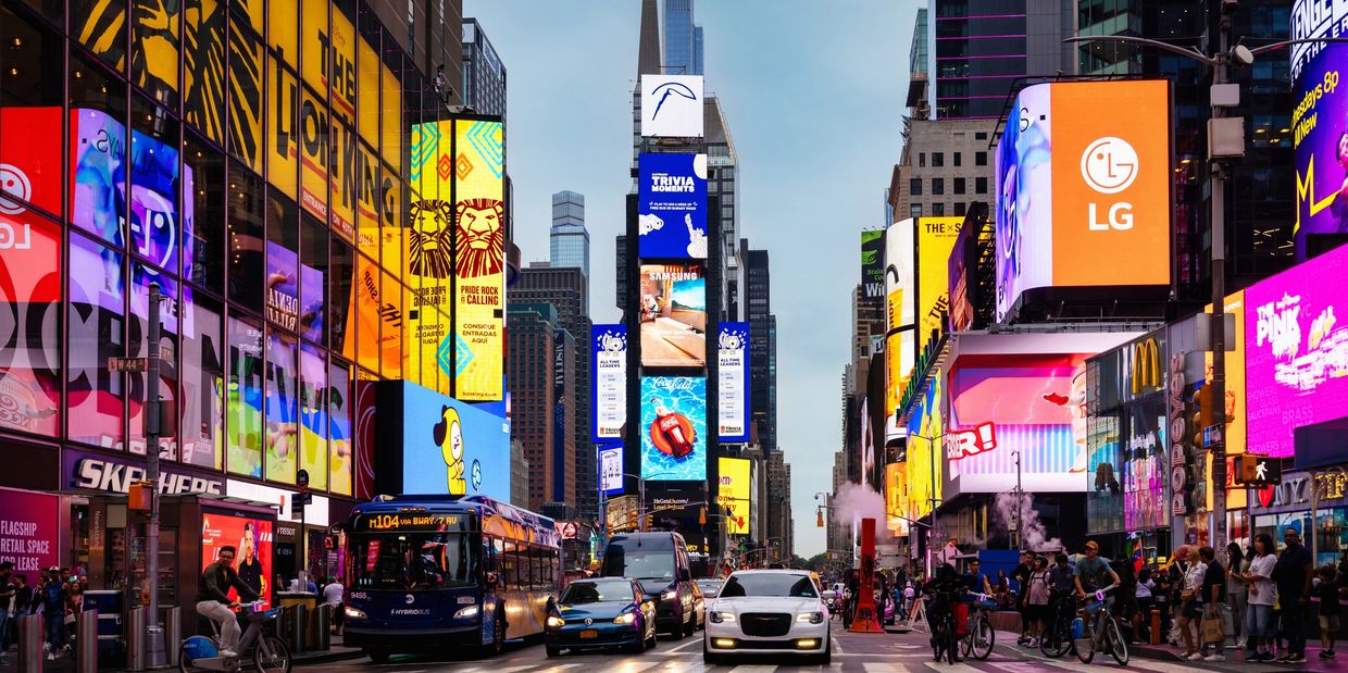 Busy Times Square with vibrant billboards and traffic.