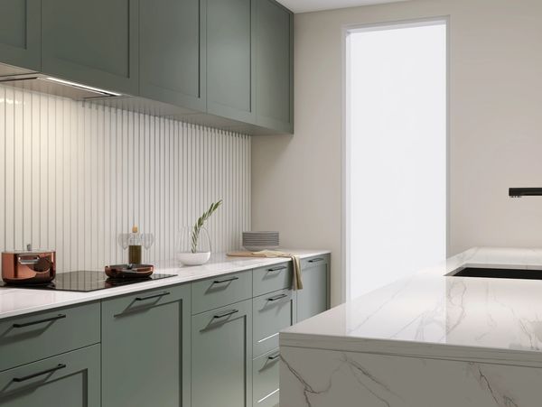 Modern kitchen with green cabinets, marble countertops, and minimalist decor.