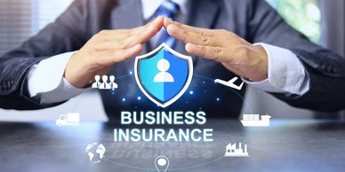 Businessman protecting digital shield symbolizing business insurance.