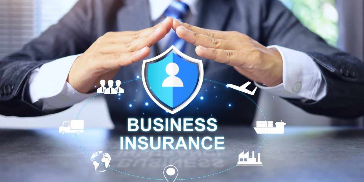 Business insurance concept with a protective shield and icons representing various industries.
