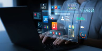Person working on UI/UX design with digital interface on laptop.