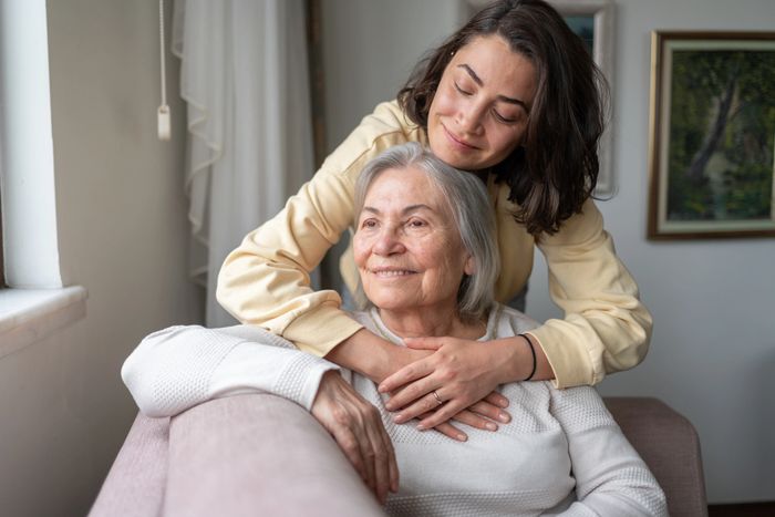 A nurse and an elderly woman pose for the camera.