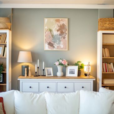 Cozy living room with a white sofa and decorative sideboard.