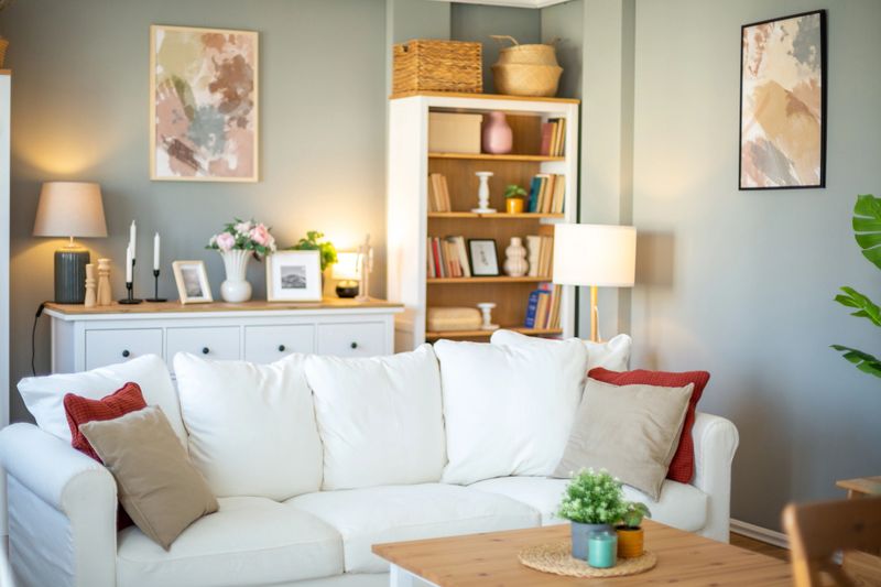 Cozy and stylish living room with white sofa, wooden furniture, and tasteful decorations, creating a welcoming atmosphere