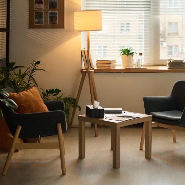 Cozy living room with two armchairs and a wooden table.