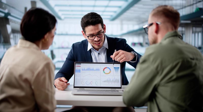 Financial Future Discussion: Couple Meets With Hispanic Planner In Office