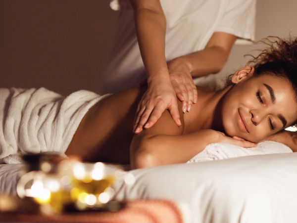 Woman enjoying a relaxing back massage at a spa.