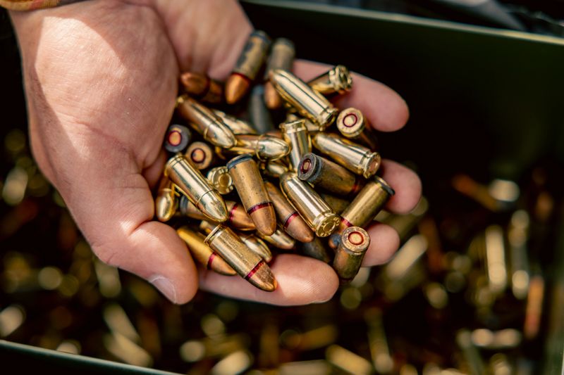 full metal jacket ammunition held in a man's hand. many cartridges for the machine gun in the hand