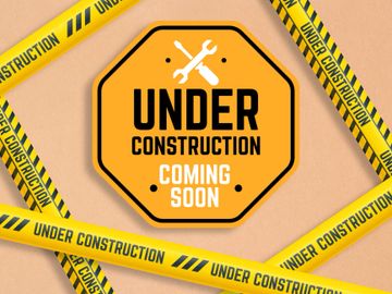 Bright yellow under construction sign with caution tape on beige background.