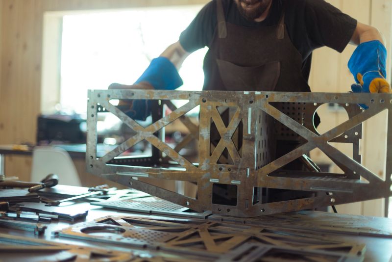 Unrecognizable and focused metalworker engaged in welding task in industrial facility