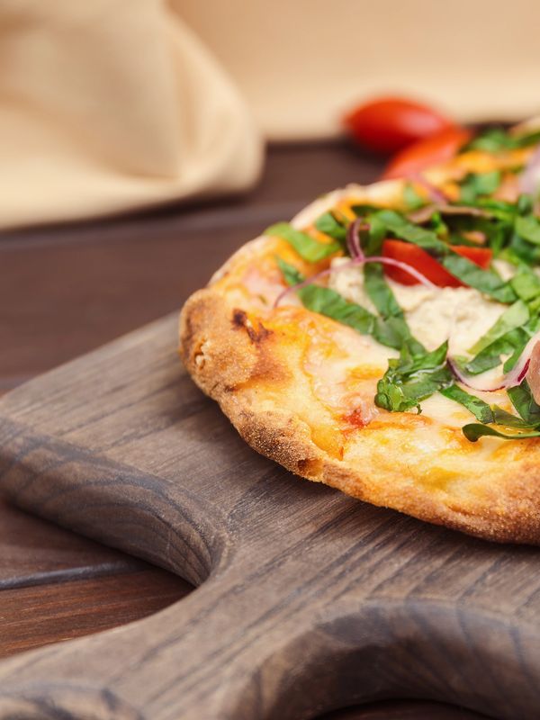 Close-up of pizza on a wooden board.