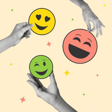 Hands holding colorful emoticon faces representing different emotions.