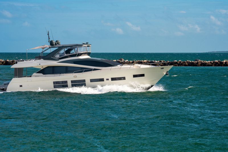 Yacht sailing on sea waters. Luxury superyacht at sea. Miami Beach with yachts. Seascape with a sailboat. Cruise ship near the coastline. Sunset yacht voyage. Luxury sailboat yacht. Boating