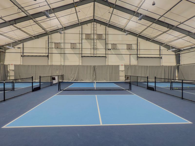 An indoor pickleball court is a designated playing area inside a gymnasium or sports facility, designed to match the official dimensions and layout used in competitive play