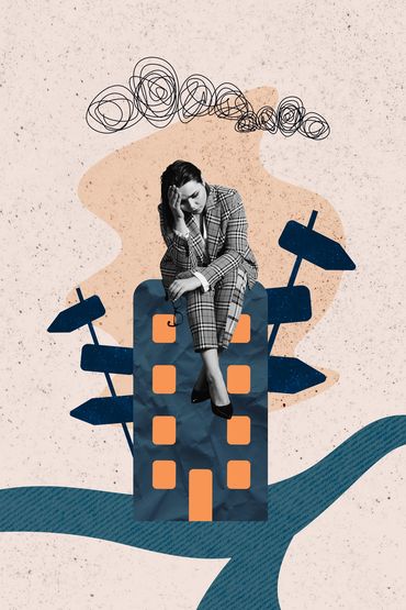 Woman sitting in tension, holding her head in her hands