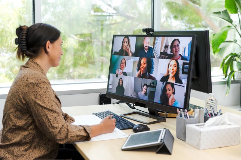 Woman leads a virtual meeting with colleagues. Online teamwork and communication.