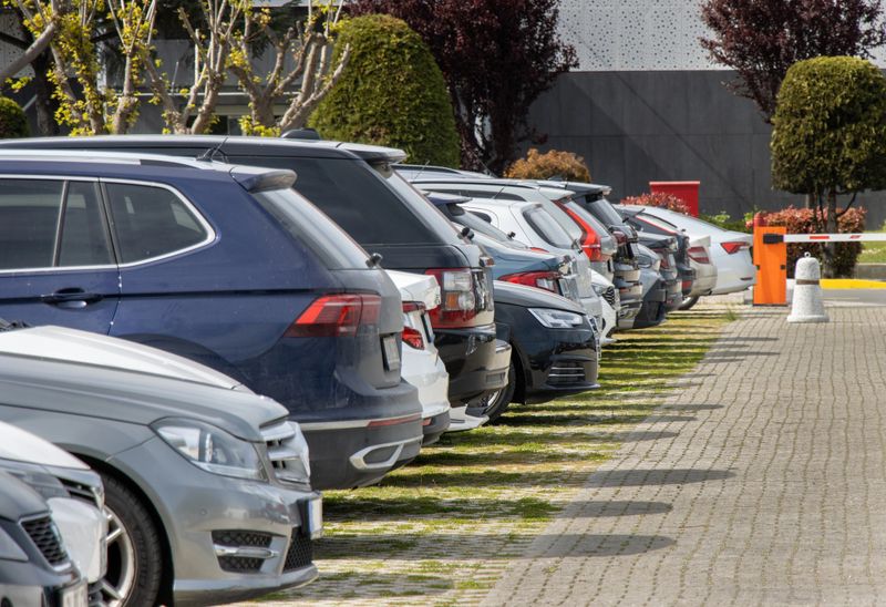 Cars are parked in an orderly manner in an open area parking lot