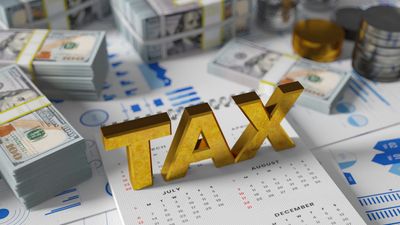 TAX in gold letters with money, charts, and calendar — symbolizing NYC tax planning and accounting.