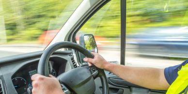 Person driving a vehicle on a highway.