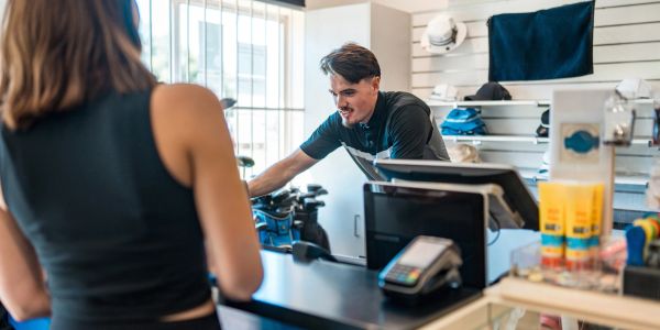 Customer interacting with a store clerk over the counter.