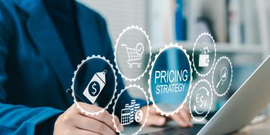 Businessman working on pricing strategy with digital icons.