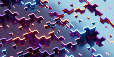 Shiny metallic puzzle pieces fitting together.