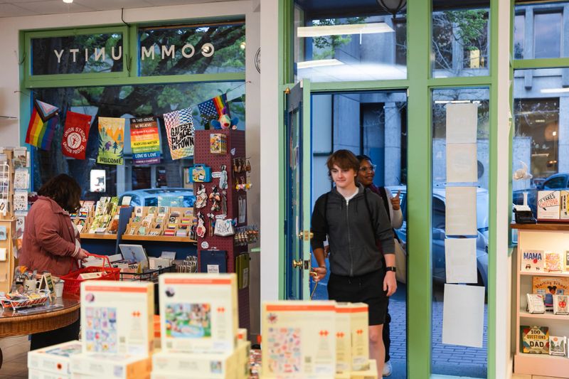 A small group of people shopping in a small locally owned bookstore. Ethnical Consumerism concept, shot in Portland Oregon, USA.