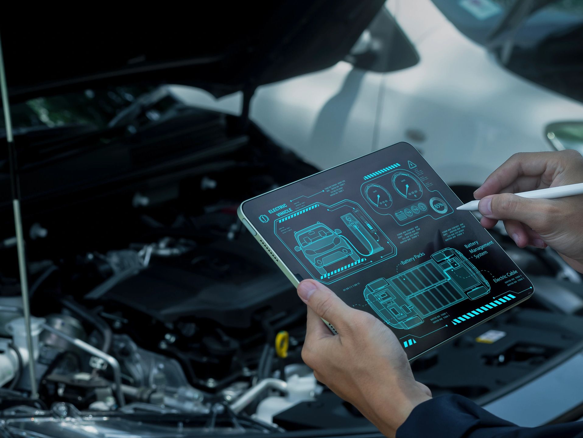 Using a tablet to diagnose an electric vehicle's battery system.