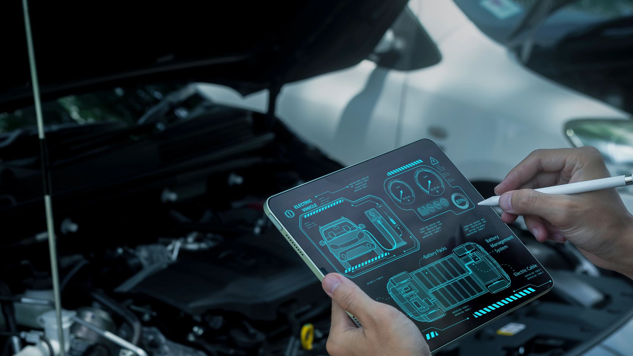 Person holding a tablet with electric vehicle diagnostics.