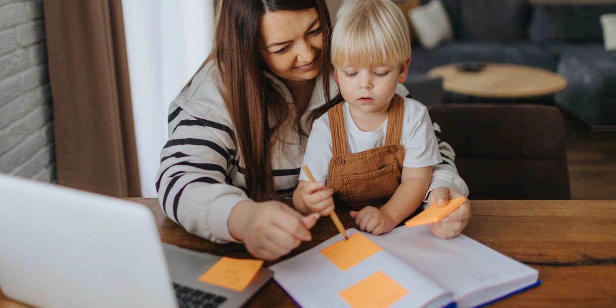 a teacher doing writing with a young boy
