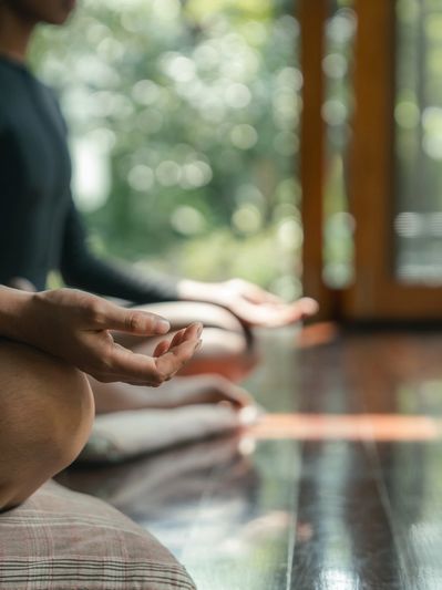 Two people meditating indoors with natural light.
