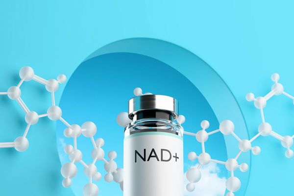 A vial labeled NAD+ with molecular structures on a blue background.