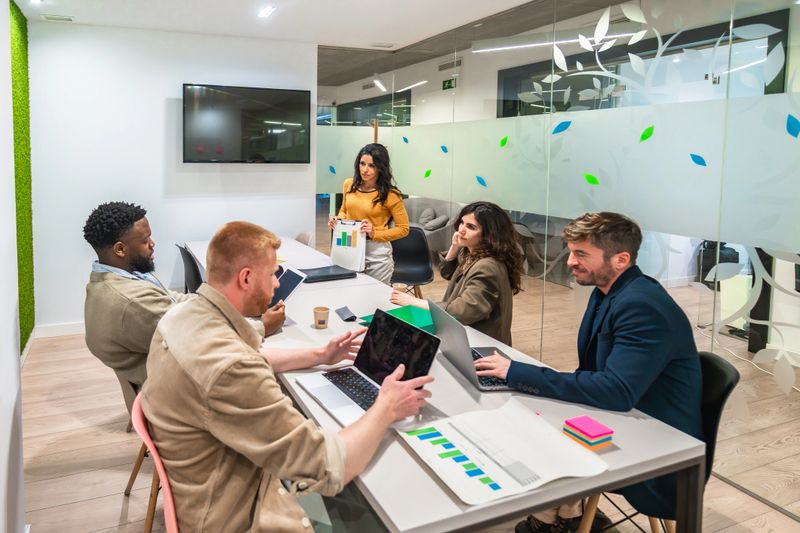 Diverse team of marketing professionals collaborates on growth strategies, analyzing data and fostering innovation in a contemporary office setting