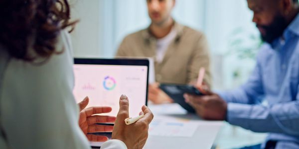 Business meeting with a focus on data analysis and discussion.