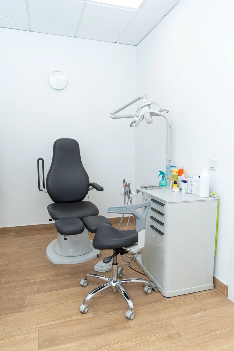 Modern podiatry treatment room equipped with specialized chair, lamp, and tools, awaiting the next patient