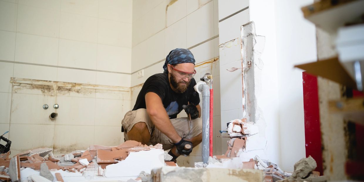 A contractor working on a bathroom remodel project.