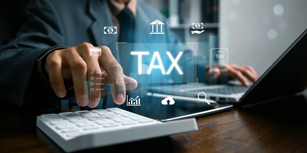 Person using calculator and laptop with digital tax icons overlay.