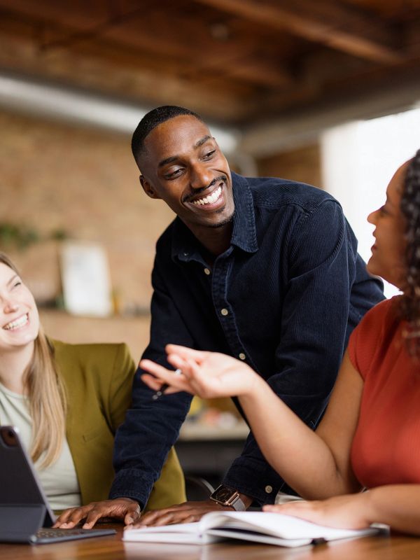 Confident businesspeople smiling and posing in a modern office.