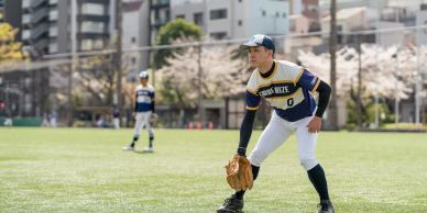 Baseball players ready on the field in city park.