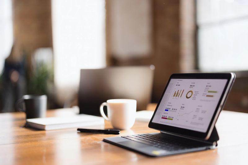 Close up of digital tablet with business chart on it at the table in the office.