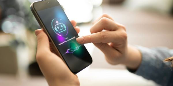 Person interacting with a voice assistant app on a smartphone.