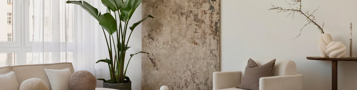 Cozy living room with neutral tones and greenery.