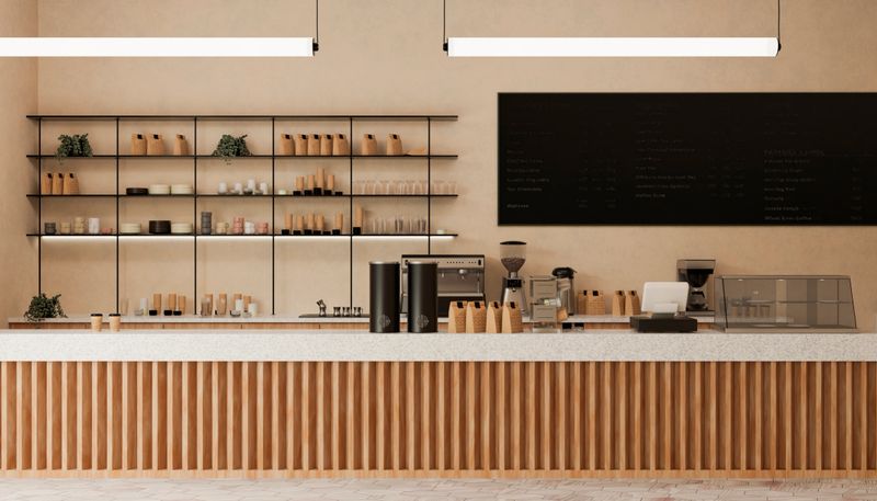 Empty modern coffee shop interior with wooden counter, shelves, coffee machine, and menu board