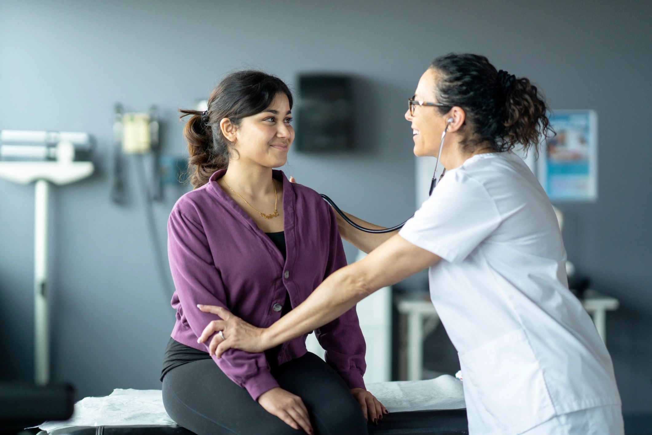 Healthcare professionals providing attentive care in a clinical setting.