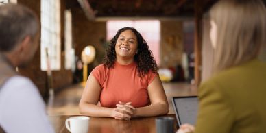 Confident woman smiling during a meeting.