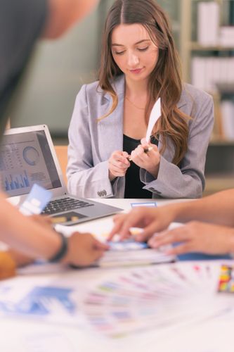 Stack of books next to pencils in a holder and a camera.