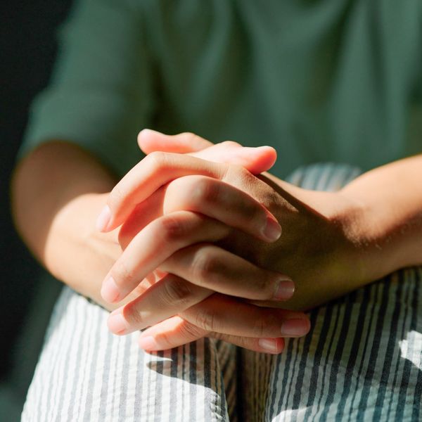 Person with clasped hands needing support and counselling